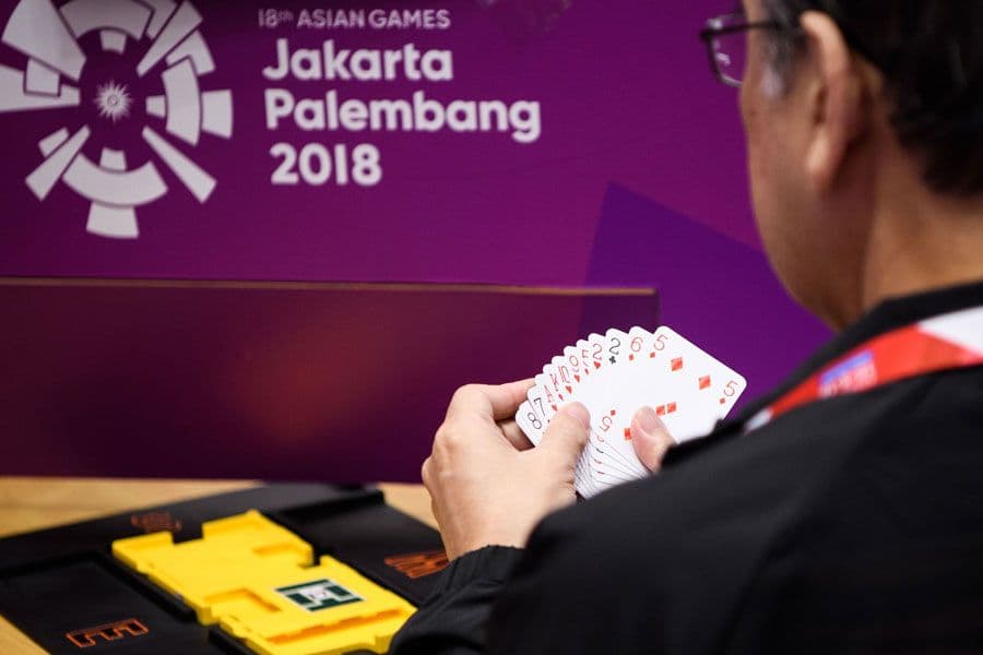 A photo of a competitor playing bridge at the asian games.