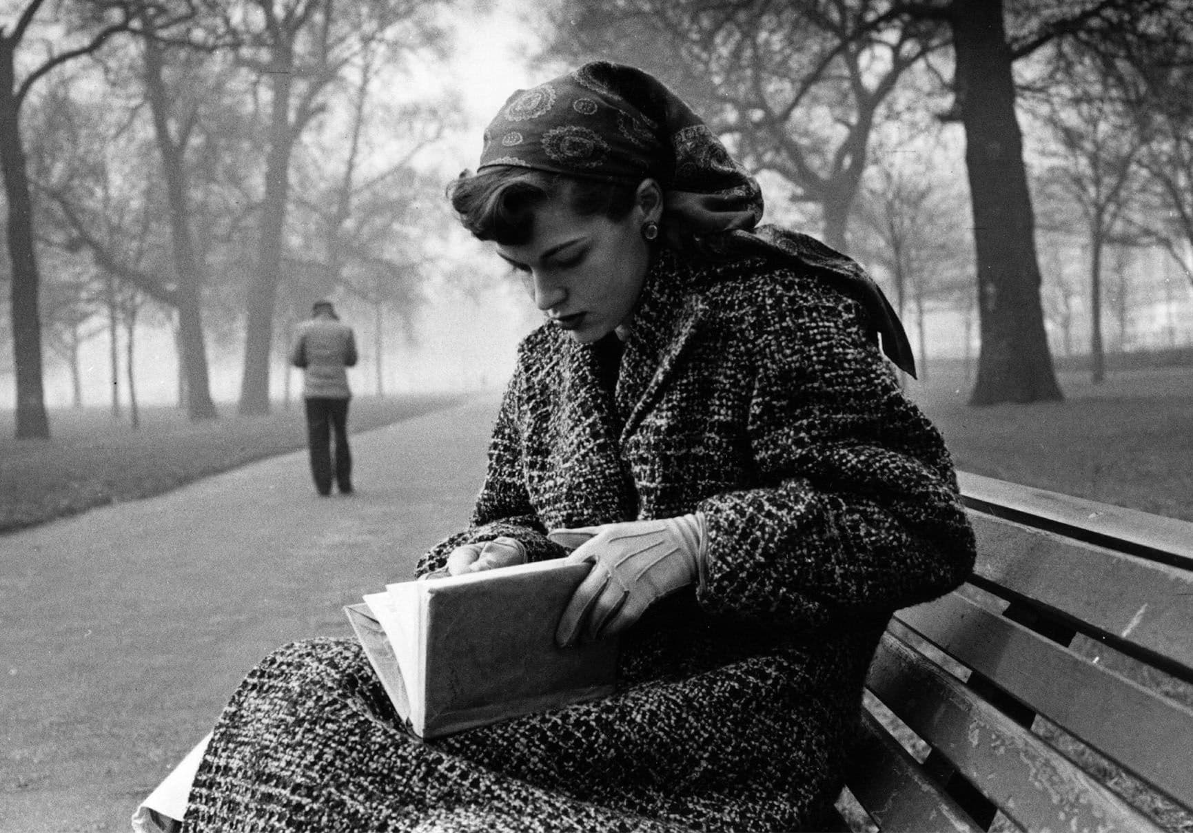 Journalist Katharine Whitehorn reading a book in London's Hyde Park. Original Publication: Picture Post - 8279 - Loneliness In London - pub. 1956 (Photo by Bert Hardy/Getty Images)