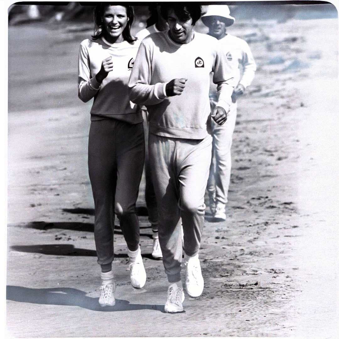 Model Cheryl Tiegs and her husband, Stan Dragoti, running on the beach at the La Costa Resort Hotel and Spa, in Carlsbad, California, 1976