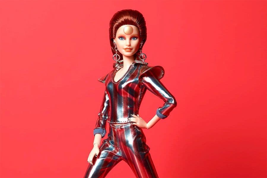 Barbie as Ziggy Stardust wearing a silver and red spacesuit.